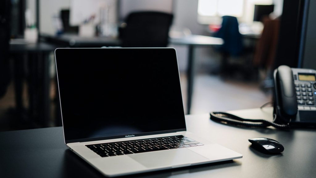 macbook pro on white table